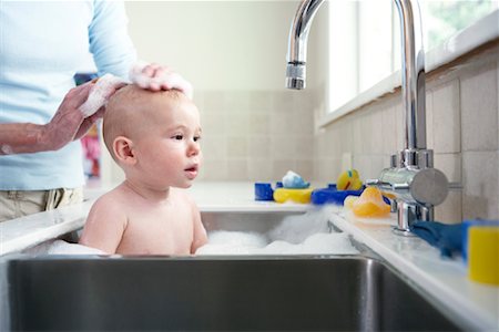 Baby Bathing in Kitchen Sink Stock Photo - Rights-Managed, Code: 700-01587011
