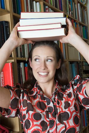 Woman Holding Books on Her Head Stock Photo - Rights-Managed, Code: 700-01587358