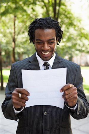 dreadlocks on african americans - Portrait of Businessman Reading Document Stock Photo - Rights-Managed, Code: 700-01615237