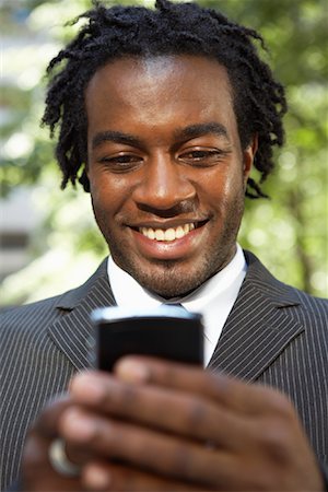 dreadlocks on african americans - Businessman Reading Text Message Stock Photo - Rights-Managed, Code: 700-01615232