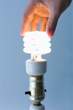 Woman Installing Fluorescent Light Bulb Stock Photo - Rights-Managed, Code: 700-01646207
