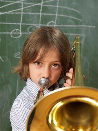 Boy Playing Trombone in Classroom Foto de stock - Con derechos protegidos, Código: 700-01646390