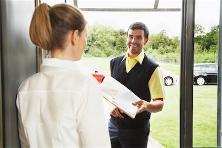 Delivery Person Giving Package to Woman Stock Photo - Rights-Managed, Code: 700-01716484