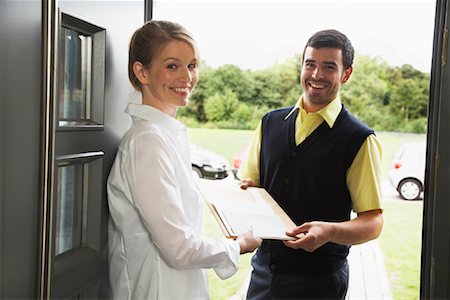 Delivery Person Giving Package to Woman Stock Photo - Rights-Managed, Code: 700-01716486