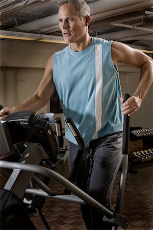 Mature Man Working Out on Elliptical Trainer Stock Photo - Rights-Managed, Code: 700-01717071