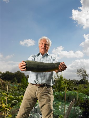 reaction - Man Holding Zucchini in Garden Stock Photo - Rights-Managed, Code: 700-01718050