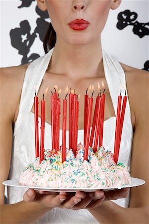 simsearch:600-02461257,k - Woman Blowing Out Candles on Birthday Cake Stock Photo - Rights-Managed, Code: 700-01880497