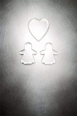 quality concept - Two Gingerbread Women Cookie Cutters with Heart Shaped Cookie Cutter Stock Photo - Rights-Managed, Code: 700-01955414
