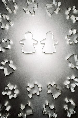 putting the pieces together - Two Gingerbread Women Cookie Cutters, Surrounded by Others Stock Photo - Rights-Managed, Code: 700-01955411