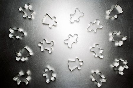 putting the pieces together - Scattered Gingerbread Men and Gingerbread Women Cookie Cutters Stock Photo - Rights-Managed, Code: 700-01955426