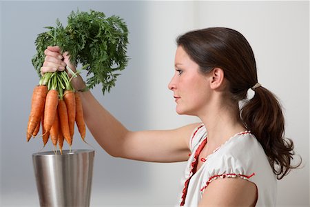 eco friendly home - Woman Placing Bunch of Carrots into Container Stock Photo - Rights-Managed, Code: 700-02010072