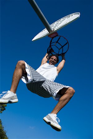 simsearch:632-06317210,k - Man Hanging from Basketball Net Foto de stock - Con derechos protegidos, Código: 700-02038086