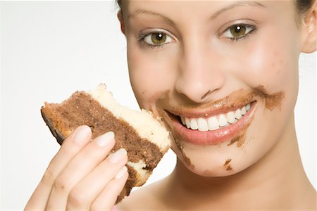 delicious enjoying food - Woman With Chocolate on Her Face Eating Cake Stock Photo - Rights-Managed, Code: 700-02038099