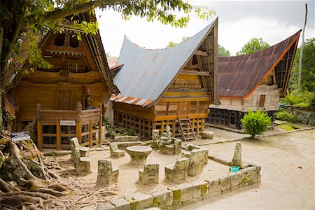 Stone Chairs and Table by Traditional Buildings, Lake Toba, Sumatra, Indonesia Stock Photo - Rights-Managed, Code: 700-02046533