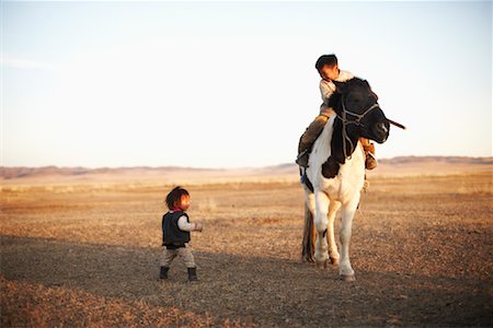 Children in Field with Horse, Khustain Nuruu National Park, Mongolia Stock Photo - Rights-Managed, Code: 700-02046996