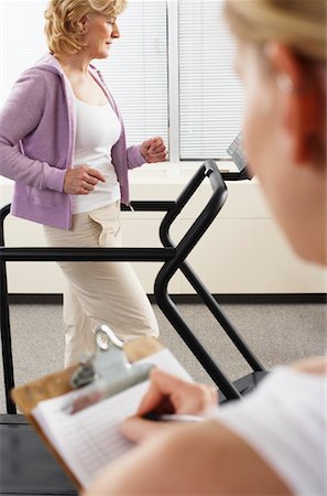 fitness older women gym - Woman using Treadmill with Physiotherapist Checking Progress Stock Photo - Rights-Managed, Code: 700-02071772