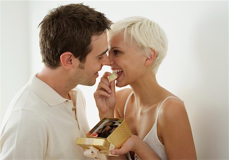 flirty couple blond smile - Young Couple with Box of Chocolates Stock Photo - Rights-Managed, Code: 700-02129041