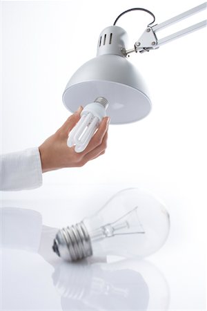 Replacing Incandescent Lightbulb With Energy Efficient Lightbulb Foto de stock - Con derechos protegidos, Código: 700-02130470