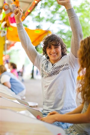 show off male - Teenage Boy Celebrating Win at an Amusement Park Stock Photo - Rights-Managed, Code: 700-02200324