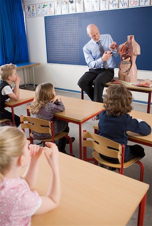 preteen girls looking older - Teacher and Students in Classroom with Anatomy Manequin Stock Photo - Rights-Managed, Code: 700-02217458