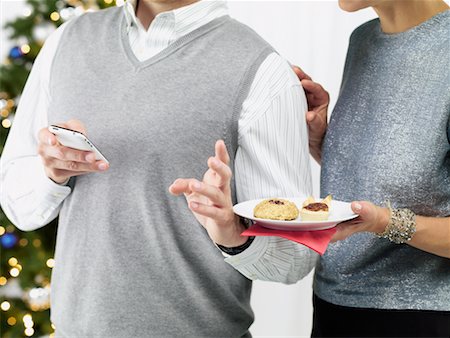 Couple at a Christmas Party, Woman Trying to Get Man's Attention Stock Photo - Rights-Managed, Code: 700-02264266