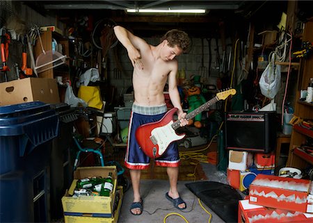 Boy Playing Electric Guitar in Garage Stock Photo - Rights-Managed, Code: 700-02264756