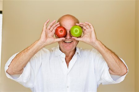 Man Holding Apples in Front of Eyes Stock Photo - Rights-Managed, Code: 700-02265711