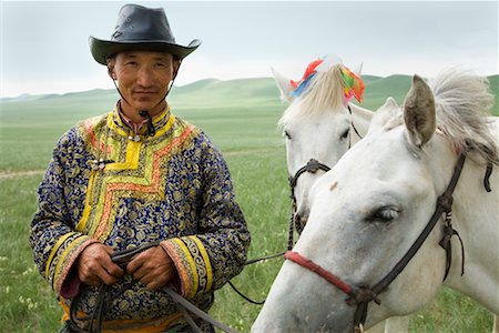 Man With Horses at the Naadam Festival, Xiwuzhumuqinqi, Inner Mongolia, China Stock Photo - Rights-Managed, Code: 700-02265745
