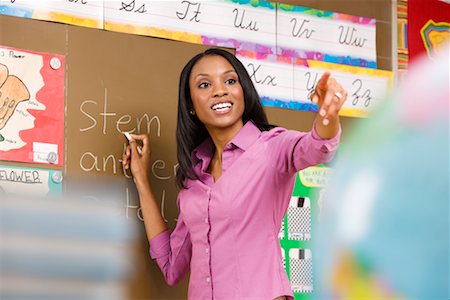 Portrait of Teacher Writing on Chalkboard Stock Photo - Rights-Managed, Code: 700-02260104