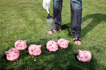 Person Watering Piggy Banks Stock Photo - Rights-Managed, Code: 700-02289299