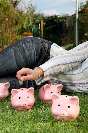 Woman on Grass with Piggy Banks Stock Photo - Rights-Managed, Code: 700-02289313