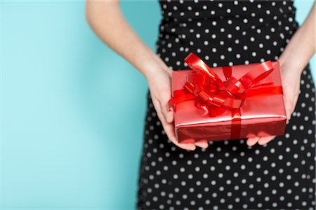 polka dot gift wrap - Woman Holding Present Behind Back Stock Photo - Rights-Managed, Code: 700-02332666