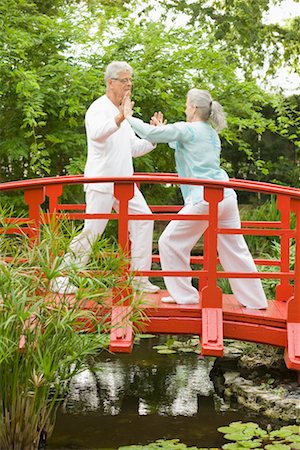 Couple Practicing Tai Chi on Footbridge Stock Photo - Rights-Managed, Code: 700-02332683