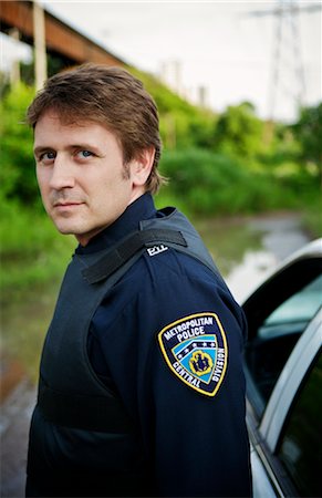 Portrait of Police Officer by Cruiser, Toronto, Ontario, Canada Stock Photo - Rights-Managed, Code: 700-02348227