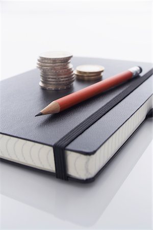 Pencil and Stack of Coins on Notebook Stock Photo - Rights-Managed, Code: 700-02371479