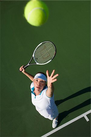 Woman Serving Tennis Ball Stock Photo - Rights-Managed, Code: 700-02385988