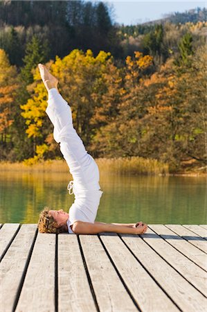 Woman Practicing Yoga on Dock, Fuschlsee, Salzkammergut, Salzburg, Austria Stock Photo - Rights-Managed, Code: 700-02428612