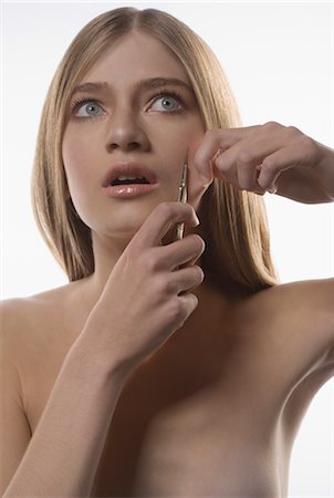 peer pressure - Girl Holding Scalpel to Face Stock Photo - Rights-Managed, Code: 700-02461486