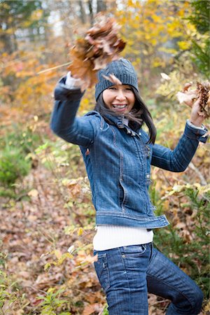 Woman Throwing Autumn Leaves Stock Photo - Rights-Managed, Code: 700-02637169