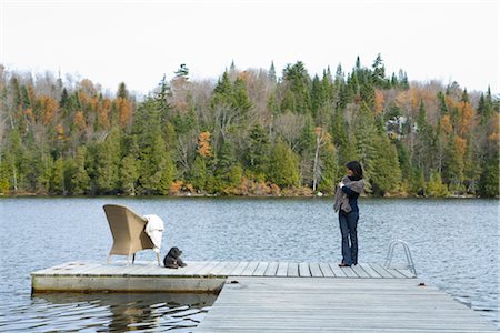 Woman on Dock with Wicker Chair and Dog Stock Photo - Rights-Managed, Code: 700-02637174