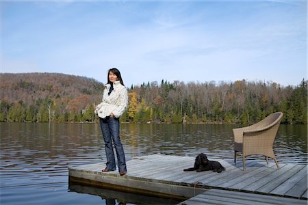 Woman on Dock with Wicker Chair and Dog Foto de stock - Con derechos protegidos, Código: 700-02637177