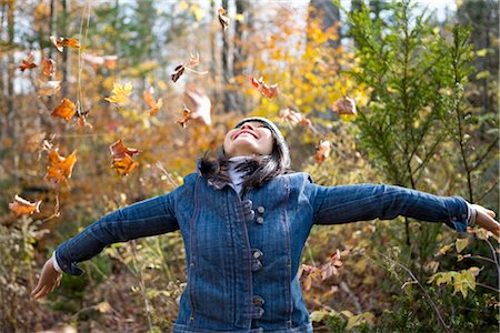 Woman Throwing Autumn Leaves Stock Photo - Rights-Managed, Code: 700-02637171