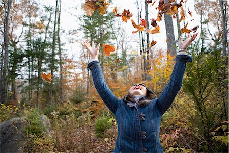 Woman Throwing Autumn Leaves Stock Photo - Rights-Managed, Code: 700-02637173