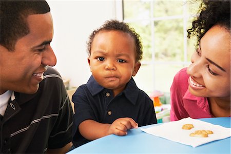 Toddler Eating Cookies with Parents Stock Photo - Rights-Managed, Code: 700-02637954