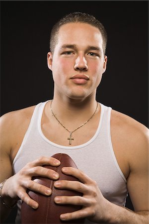 football player (american sport, male) - Portrait of Man Holding Football Stock Photo - Rights-Managed, Code: 700-02645588