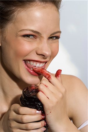 Woman Eating Jam with Fingers Stock Photo - Rights-Managed, Code: 700-02645925