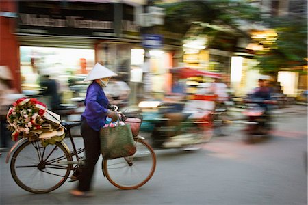 Woman with Flowers on Bicycle, Old Quarter, Hanoi, Vietnam Stock Photo - Rights-Managed, Code: 700-02669412