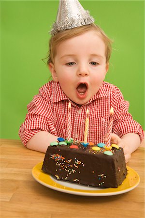 superstition - Girl Blowing out Birthday Candles Stock Photo - Rights-Managed, Code: 700-02669993