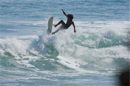 Surfer Riding Waves at Tamarindo Beach, Costa Rica Stock Photo - Rights-Managed, Code: 700-02670131