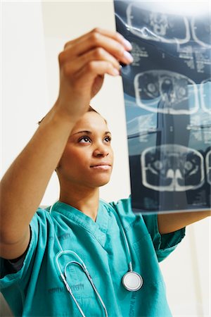 Doctor Examining X-rays Stock Photo - Rights-Managed, Code: 700-02670503